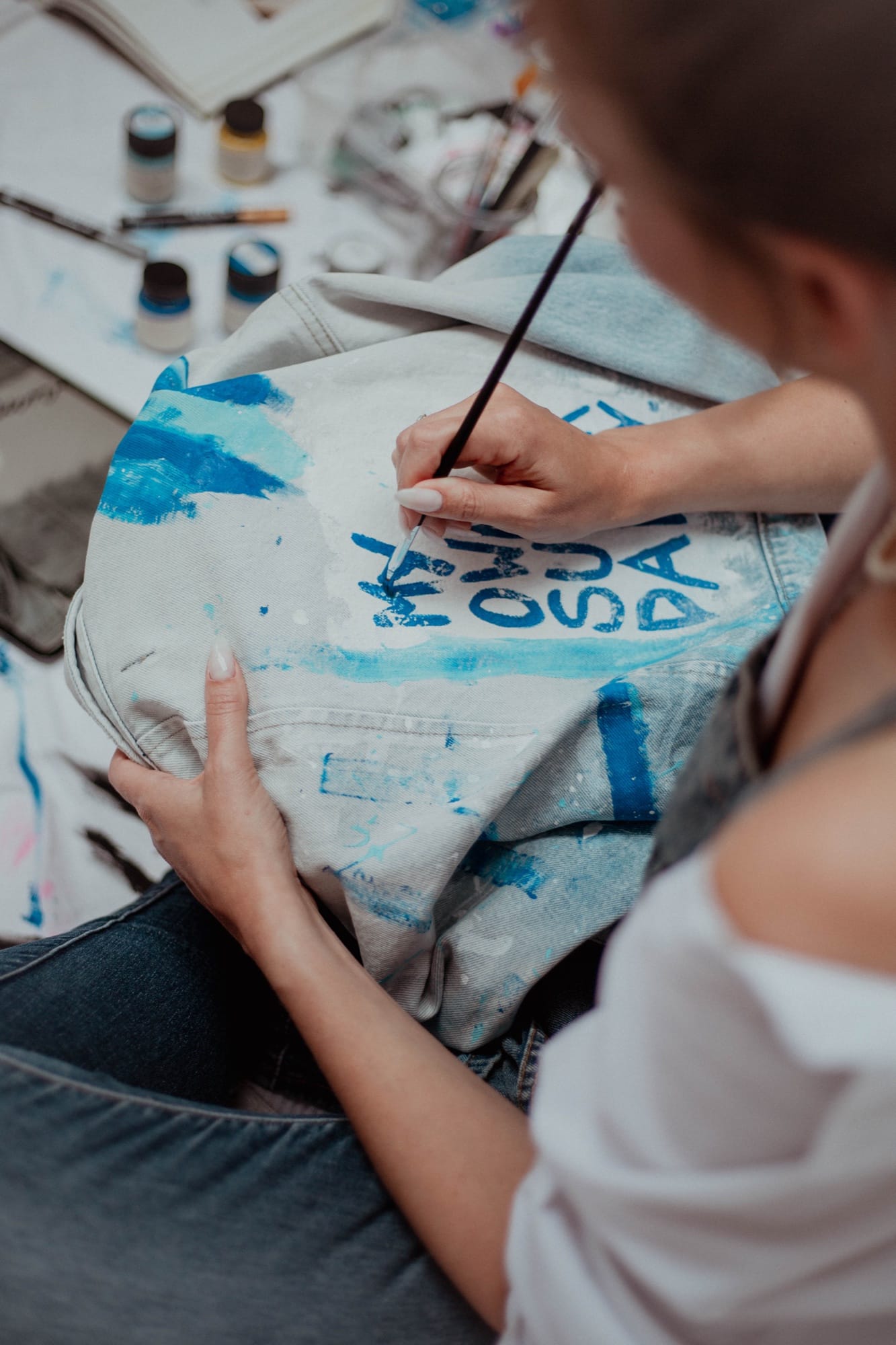 Hand painting a denim jacket
